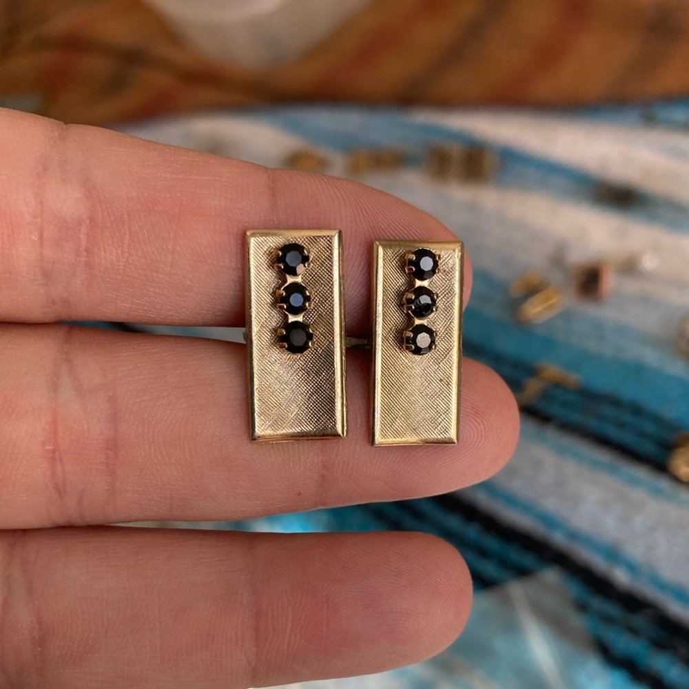 Gold cuff links with black rhinestones